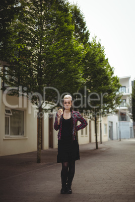 Woman standing with coffee cup