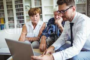 Senior couple planning their investments with financial advisor