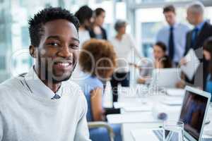 Smiling businessman sitting in office