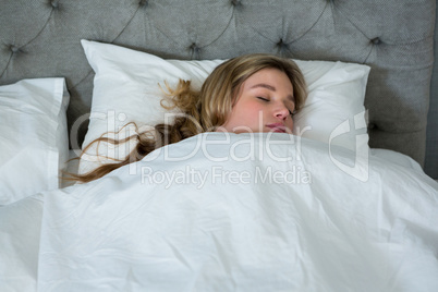 Young woman sleeping on her bed