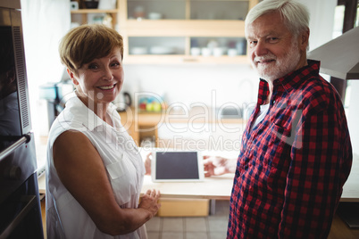 Senior couple using digital tablet