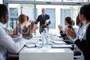 Businesspeople applauding on their colleagues presentation