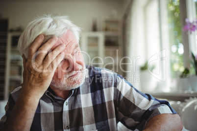 Tensed senior man looking away