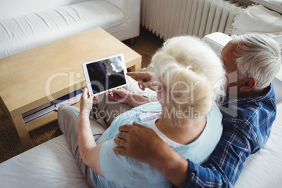 Senior couple using digital tablet