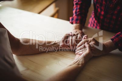 Senior couple holding hands