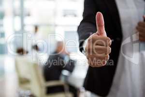 Businesswoman showing thumbs up