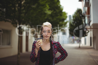 Woman standing with coffee cup