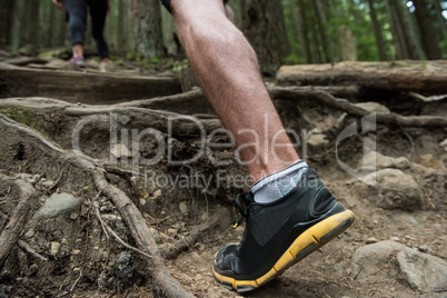 Low section of hiker hiking in countryside