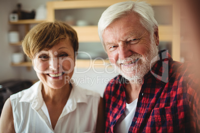 Senior couple smiling in kitchen Senior couple smiling in kitchen