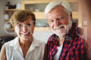 Senior couple smiling in kitchen