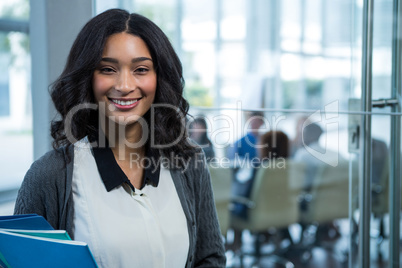 Portrait of beautiful businesswoman holding files