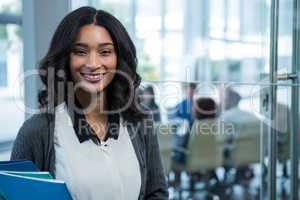 Portrait of beautiful businesswoman holding files