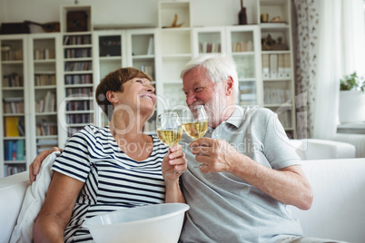 Senior couple toasting glasses of wine