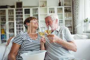 Senior couple toasting glasses of wine