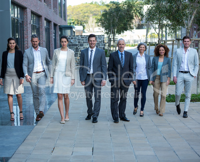 Smiling businesspeople walking in office building