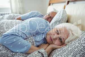 Senior woman awake on bed