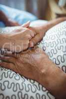 Nurse holding hands of senior woman
