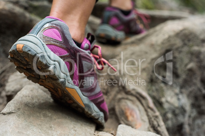 Foot of female hiker hiking in countryside