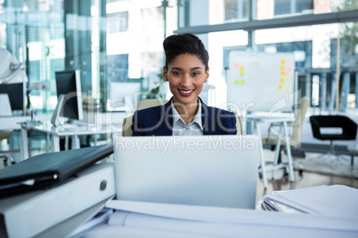 Businesswoman working on laptop in the office