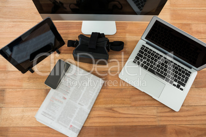Computer, laptop, digital tablet, mobile phone, virtual headset and newspaper