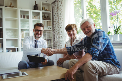 Financial advisor shaking hands with senior man