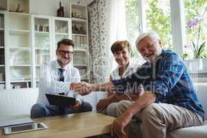 Financial advisor shaking hands with senior man