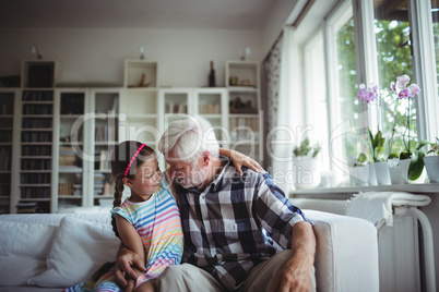 Senior man embracing his granddaughter