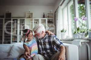 Senior man embracing his granddaughter