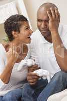 African American Couple Having Fun Playing Video Console Game