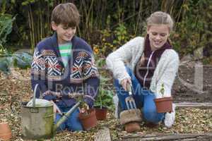 Boy and Girl Children Gardening