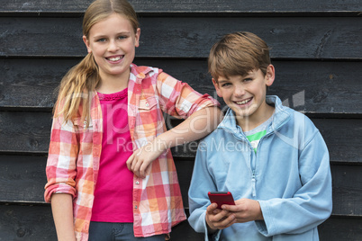 Boy and Girl Smiling Children Using Cell Phone