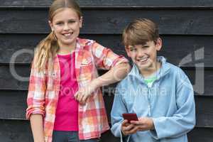 Boy and Girl Smiling Children Using Cell Phone
