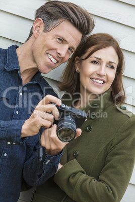 Happy Middle Aged Man and Woman Couple Using Camera