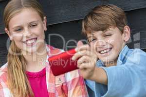 Boy and Girl Children Taking Cell Phone Selfie