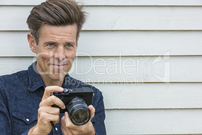 Happy Middle Aged Man Photographer Using Camera