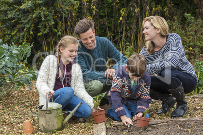 Happy Family Mother Father Son Daughter Gardening