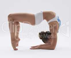 Flexible girl posing while doing acrobatic stunt