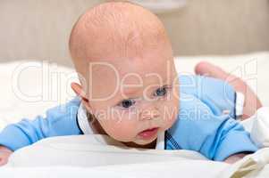 Indoor close up shot of boy lying on stomach