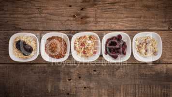 Muesli ingredients on rustic wood