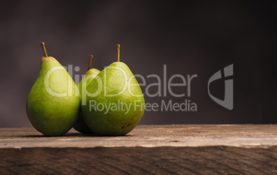 Three pears on wood