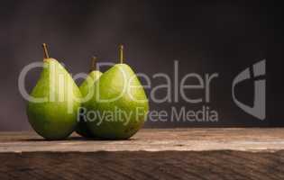 Three pears on wood