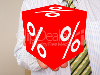 Man holds cubes with percent sign
