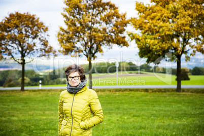 Woman with walk in autumnal scenery