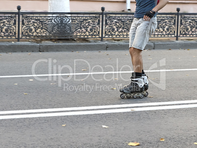 guy rides on roller skates on the road