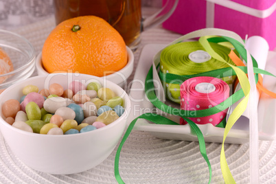 Tasty cookies and fruits with christmas gift bow set and box with cup of tea