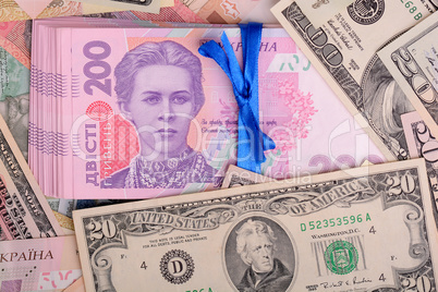 One hundred dollar bill on the background of ukrainian hryvnia and european euro