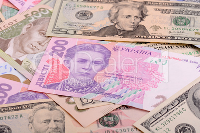 One hundred dollar bill on the background of ukrainian hryvnia a