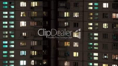 Time lapse shot of buildings and lighted windows at night