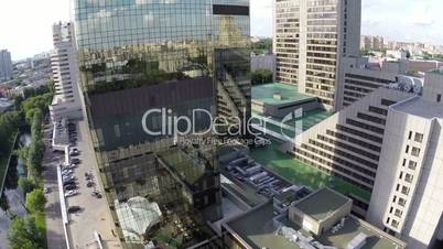 airplane view on city reflection in mirror facade of building