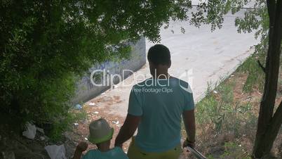 In city Perea, Greece in park down the stairs father with his son